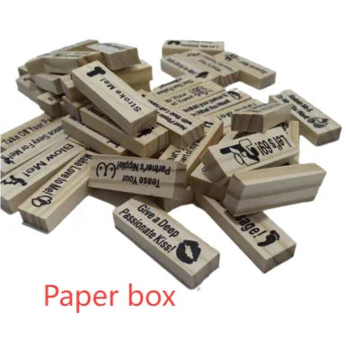 Scattered wooden game blocks with printed text and icons, party activity pieces