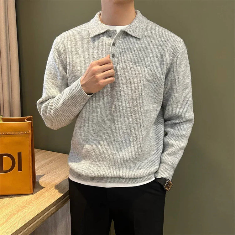Men’s light gray ribbed knit sweater, relaxed fit, collared with buttons, paired with black pants.