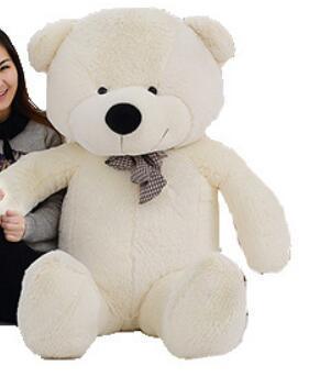 Large plush white teddy bear with a checkered bow tie, soft fur, and oversized fit.