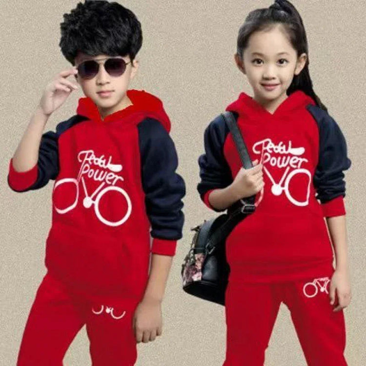 Kids in matching red and navy streetwear hooded tracksuits with graphic bicycle print.