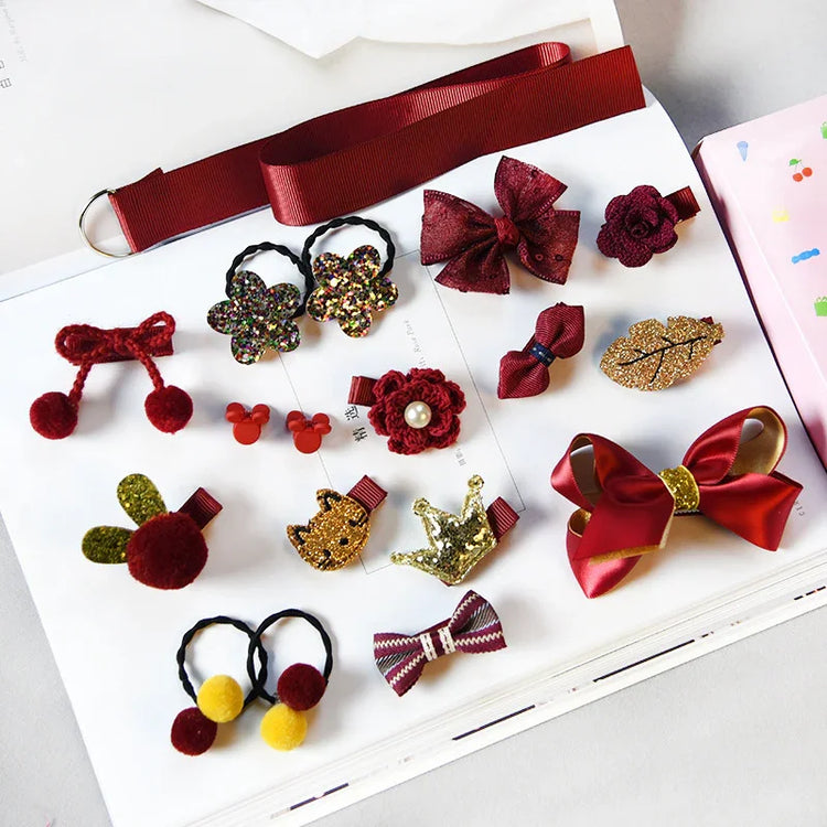Assorted red and gold hair clips and bows in velvet, glitter, and fabric, small accessory set.