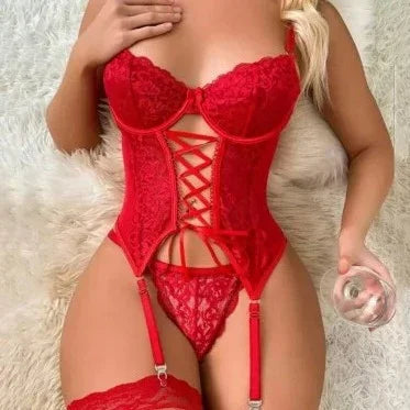 Woman wearing red lace lingerie set with corset, garter belt, and thigh-high stockings