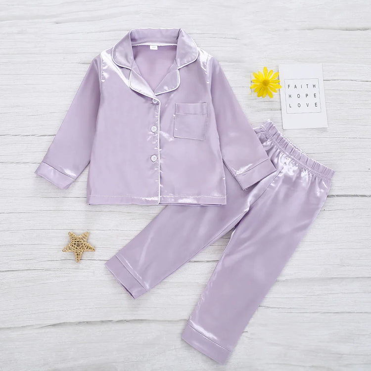 Lavender satin pajama set with button-up top, pocket, and elastic waist pants, relaxed fit