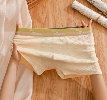 Beige ribbed knit boxer briefs with elastic waistband, soft stretch fit, casual indoor setting