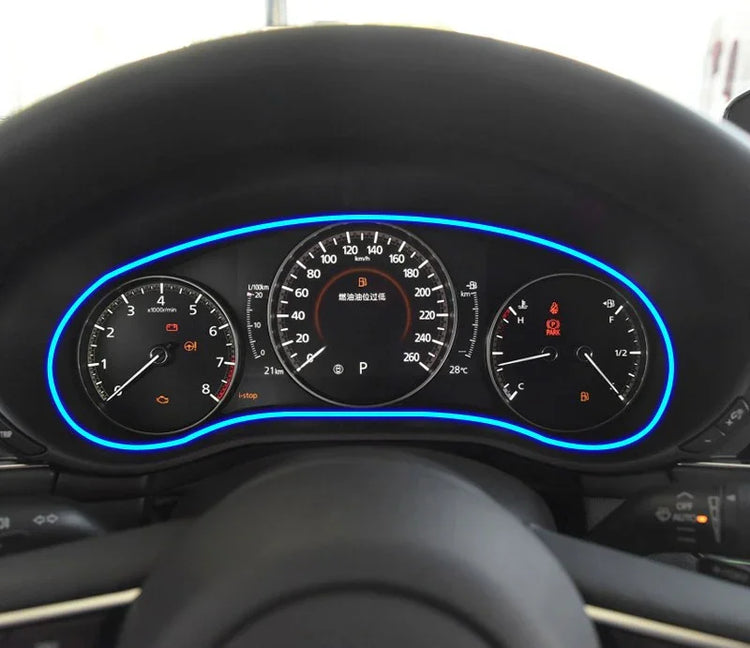Modern digital car dashboard with blue LED trim, illuminated speedometer and gauges