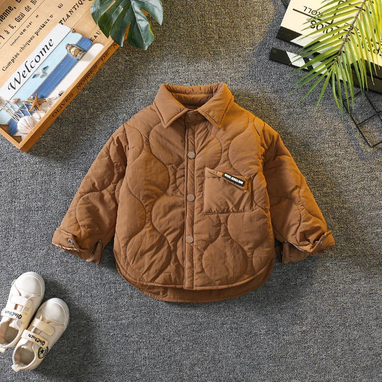 Brown quilted jacket with snap buttons, chest pocket, and relaxed fit on gray background