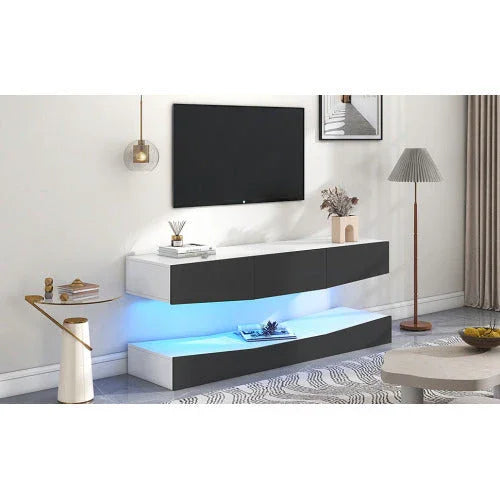 Modern minimalist black and white TV console with LED lighting and floating shelves in a stylish living room.