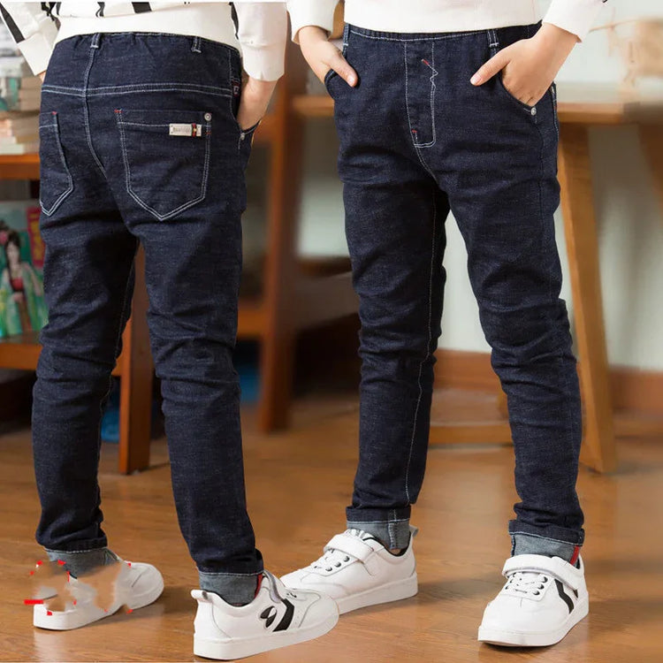 Kids wearing slim fit dark blue denim jeans with white sneakers, casual style
