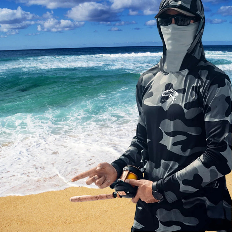 Man wearing black and grey camo hooded long sleeve fishing shirt on the beach