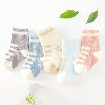 Soft cotton crew socks in pastel purple, beige, blue, and pink with striped design.