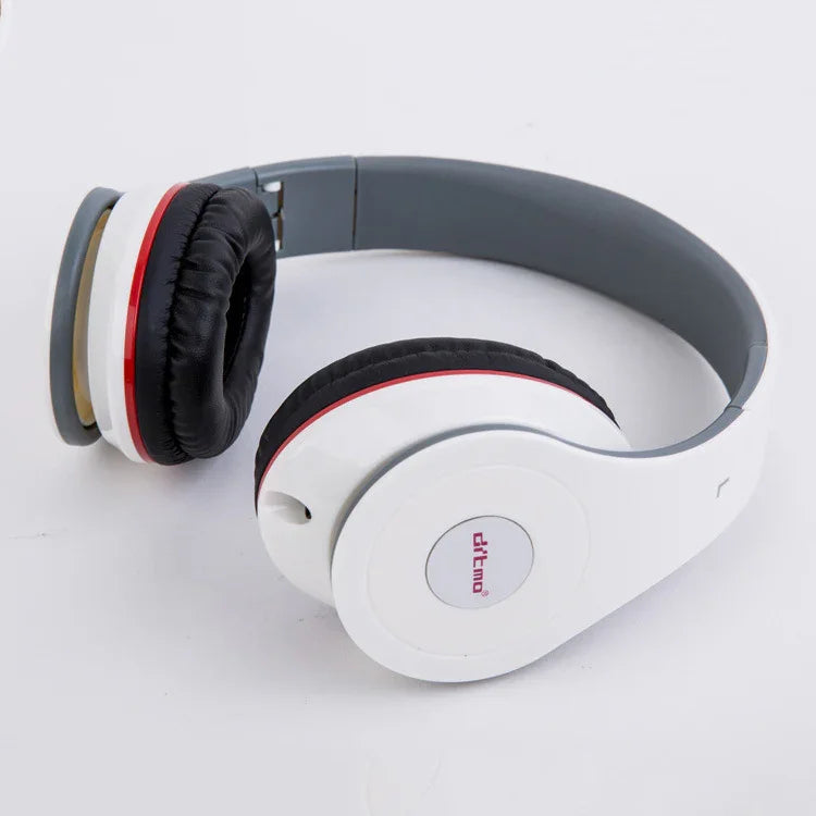 White over-ear headphones with black cushioned ear pads and red accent rings