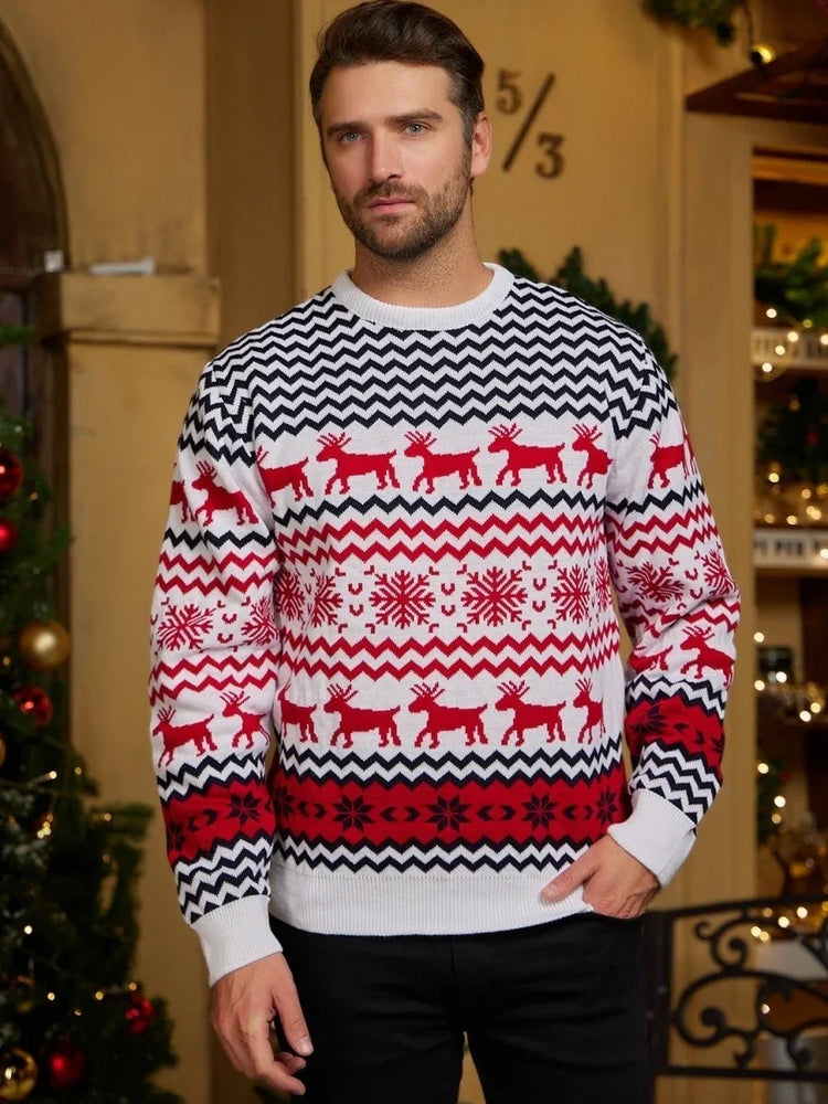 Man wearing a festive knit sweater with red, black, and white reindeer and snowflake pattern.