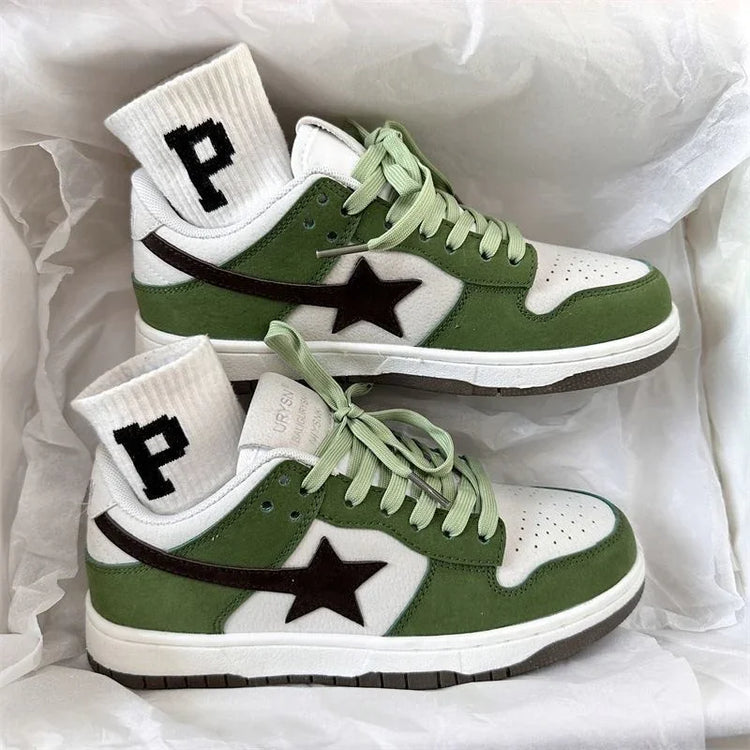 Green and white low-top suede sneakers with black star detail and white ribbed socks