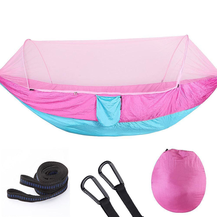 Lightweight pink and blue nylon hammock with mosquito net, straps, and carabiners included