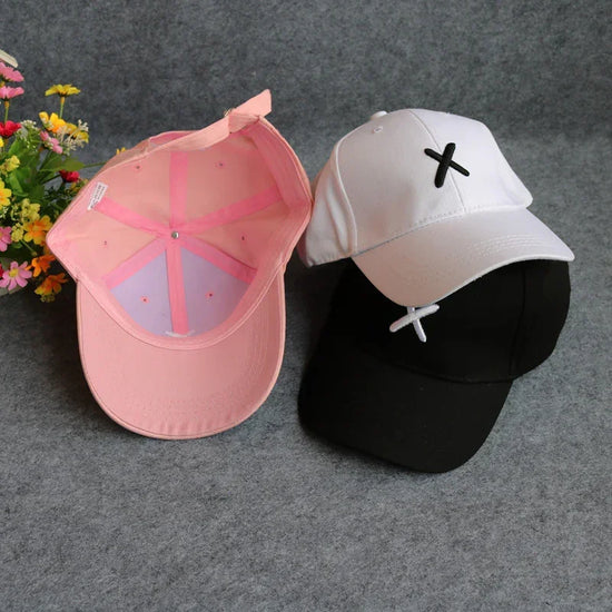 Trendy streetwear baseball caps in pink, white, and black, cotton material, relaxed fit.