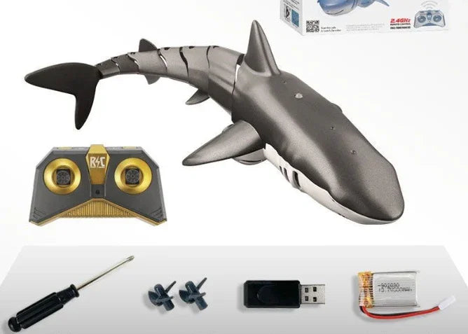 Remote control robotic shark toy set with controller, screwdriver, propellers, USB charger, and battery.