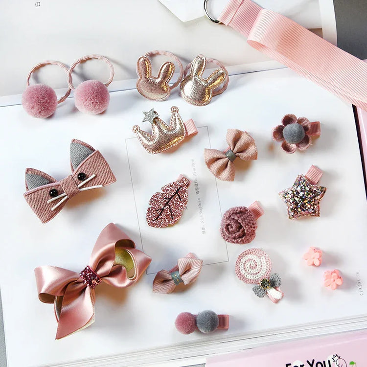 Assorted pink and glittery hair clips in various shapes like bows, stars, crowns, and flowers on a flat lay.