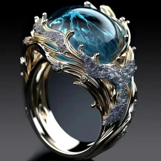 Gold ring with intricate design, blue gemstone, and silver textured accents, modern style
