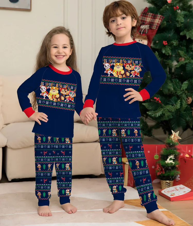 Kids wearing matching navy blue cartoon print holiday pajamas with red cuffs, relaxed fit.