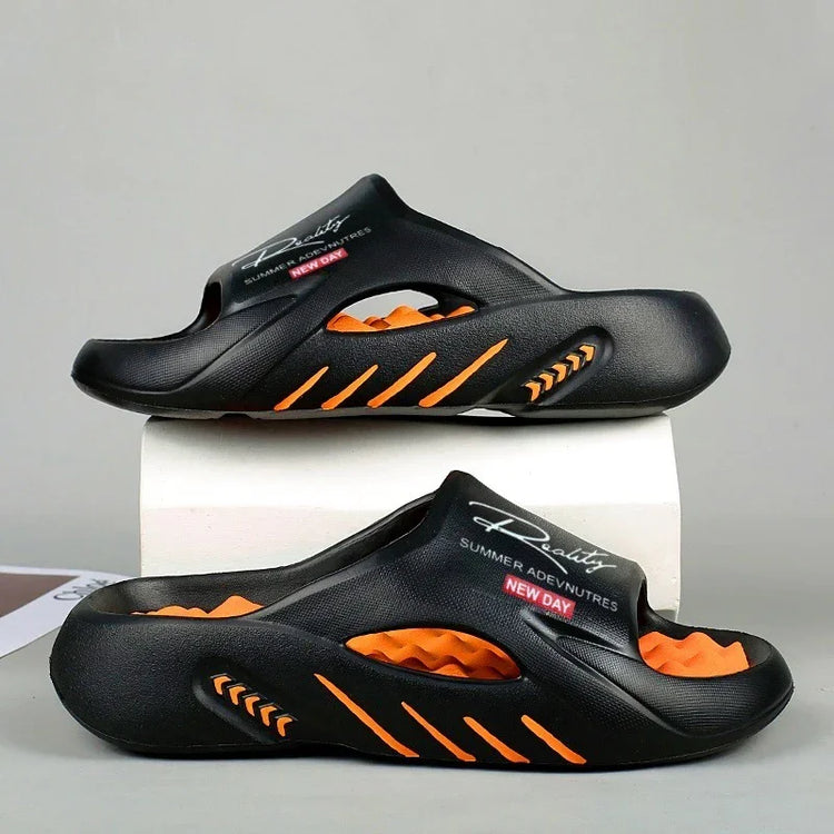 Black and orange futuristic slip-on sandals with cutout details and cushioned sole
