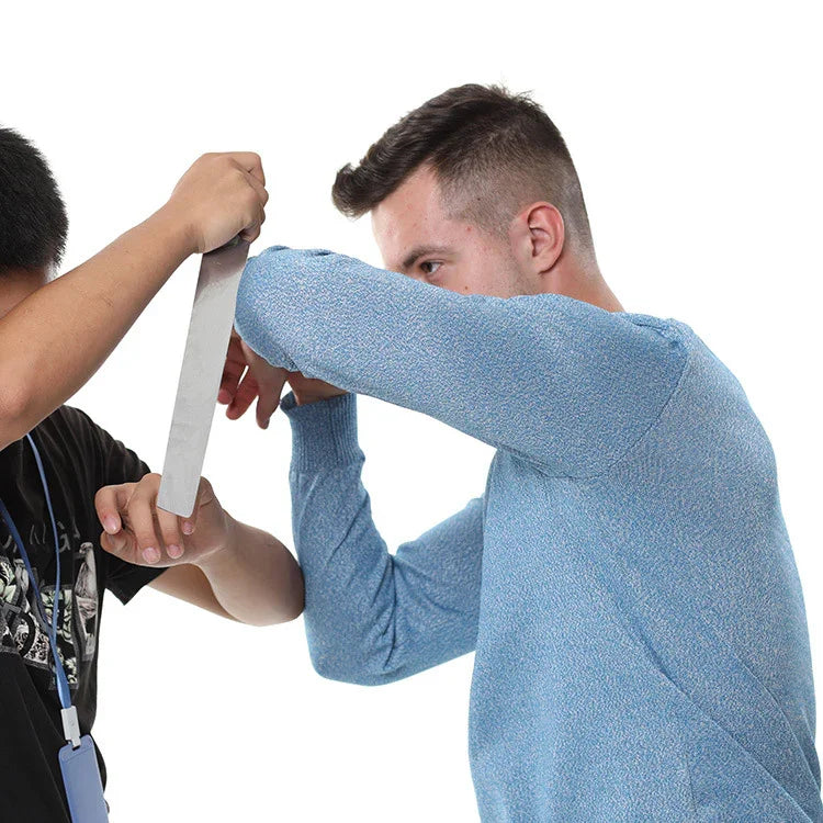 Man wearing light blue knit sweater demonstrating cut-resistant material, close fit, long sleeves