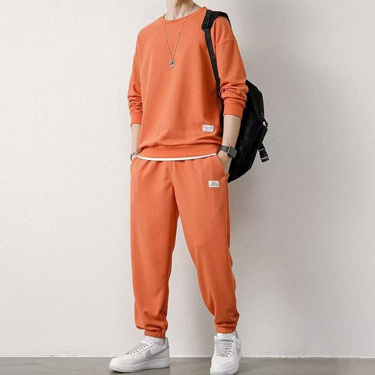 Casual orange waffle-knit sweatshirt and jogger set, relaxed fit streetwear style