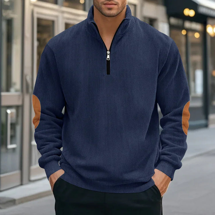 Men’s navy blue ribbed pullover with quarter-zip, tan elbow patches, relaxed streetwear fit