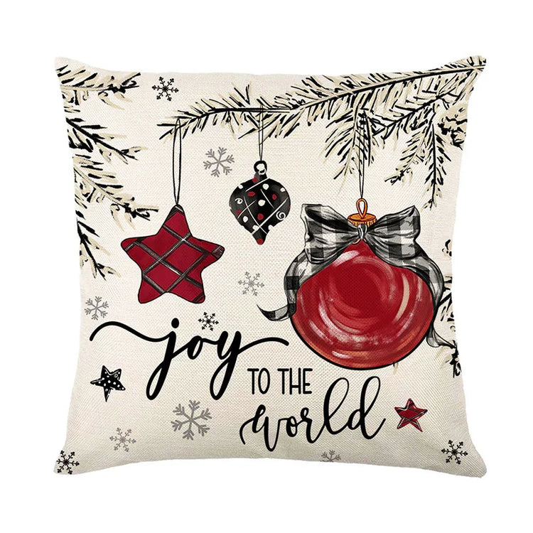 Festive throw pillow with red holiday ornaments, plaid details, and &