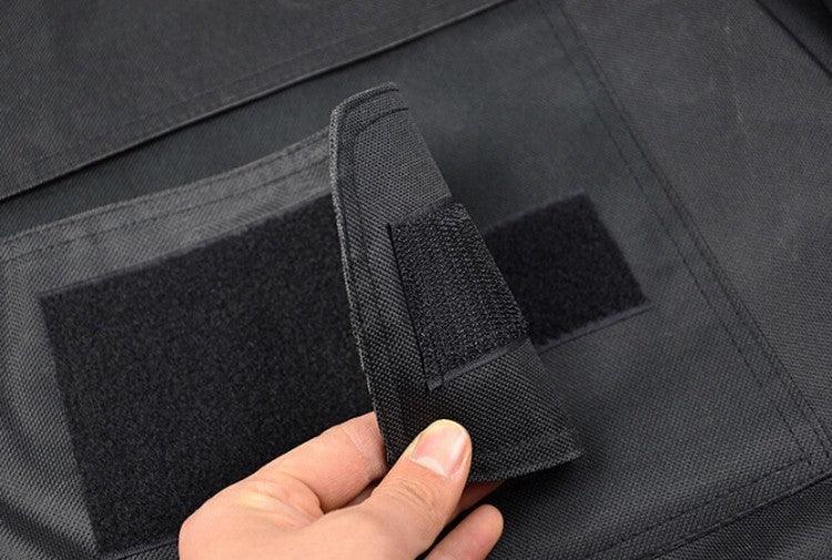Close-up of black streetwear fabric with Velcro closure, showcasing durable material and utility style