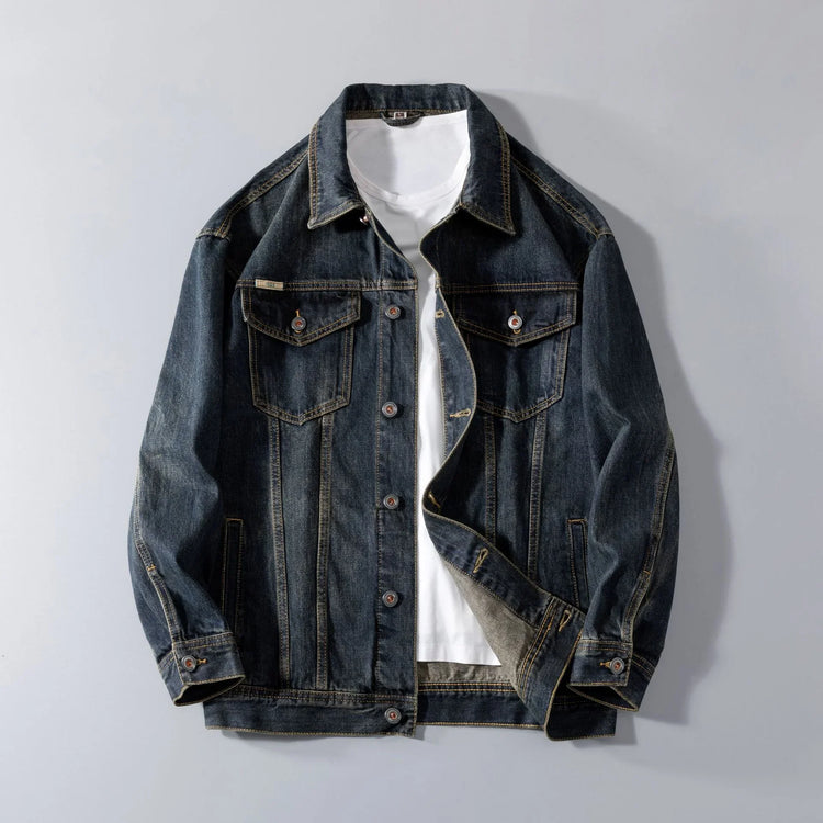 Dark blue denim jacket with button front, chest pockets, relaxed fit over white t-shirt