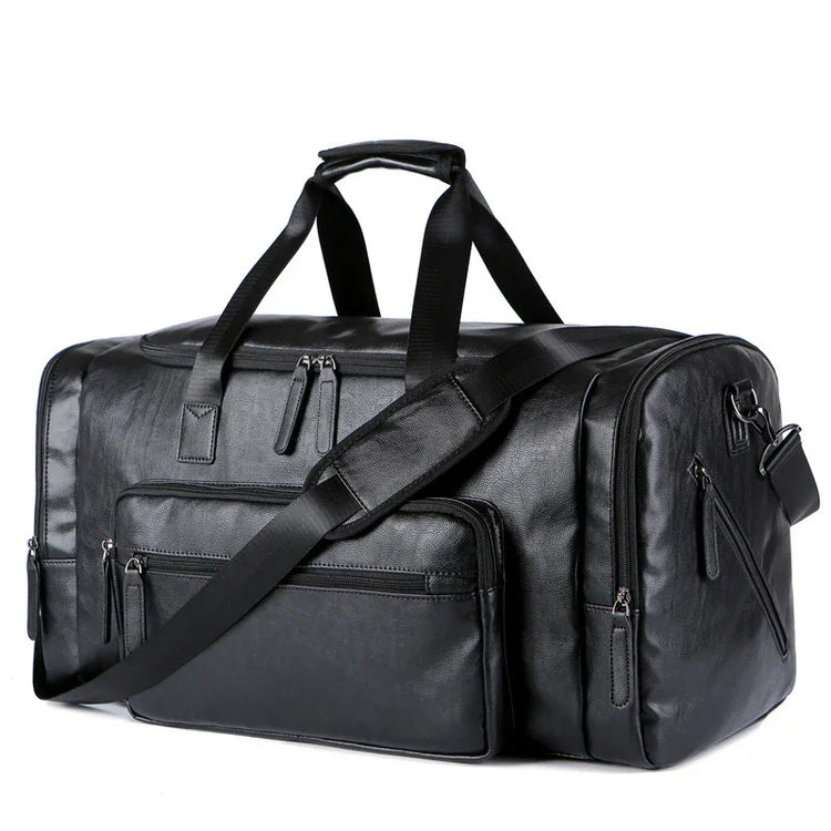 Black faux leather duffel bag with multiple zippered pockets and adjustable shoulder strap