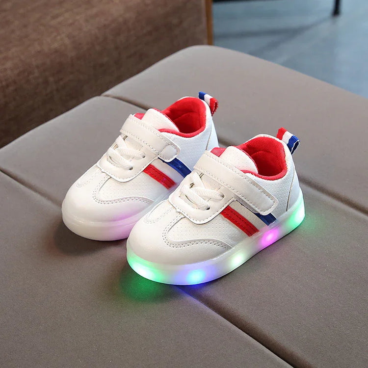 White kids sneakers with red and blue accents, light-up soles, velcro straps, mesh material