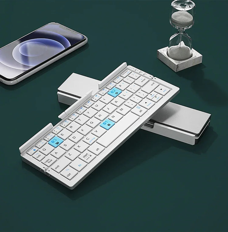 Slim foldable wireless keyboard with white keys and blue accents on a dark surface