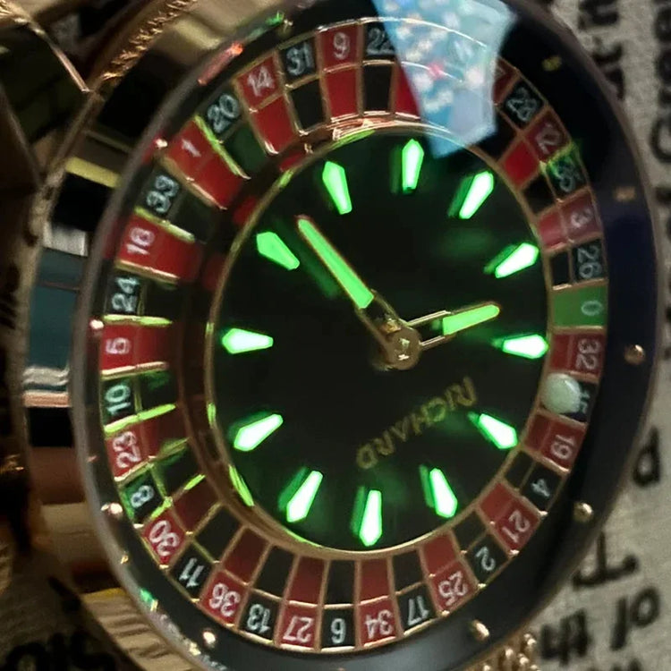 Close-up of a roulette-themed wristwatch with gold accents and glowing green markers.