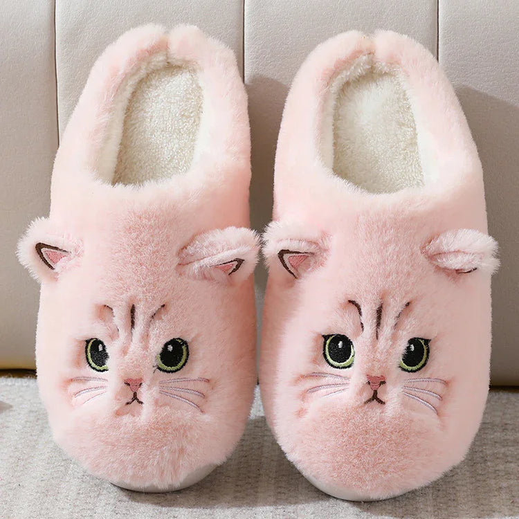 Plush pink cat slippers with embroidered face, soft fleece material, cozy fit.