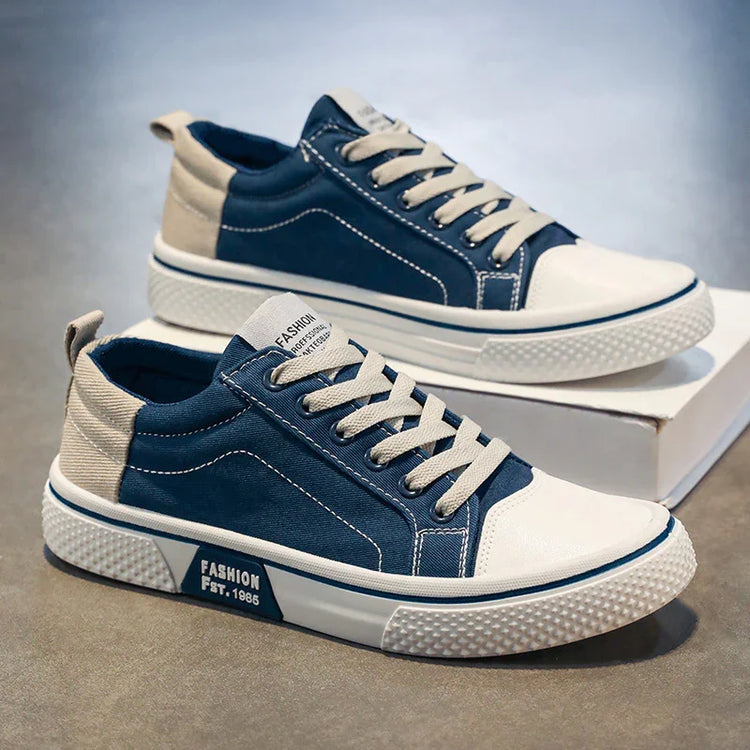 Casual blue and beige canvas sneakers with white soles and lace-up design, modern streetwear style