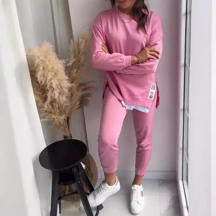 Woman wearing a pink relaxed fit cotton sweatshirt and matching jogger pants set