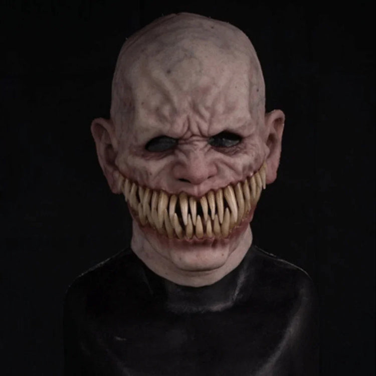 Scary silicone horror mask with sharp teeth, pale skin, and tight fit, worn with dark shirt.