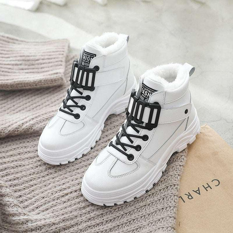 White high-top streetwear boots with black laces, chunky sole, and faux fur lining