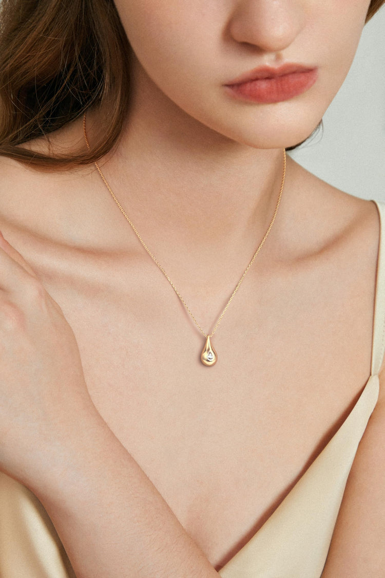 14K gold teardrop necklace for women with cubic zirconia pendant on model&