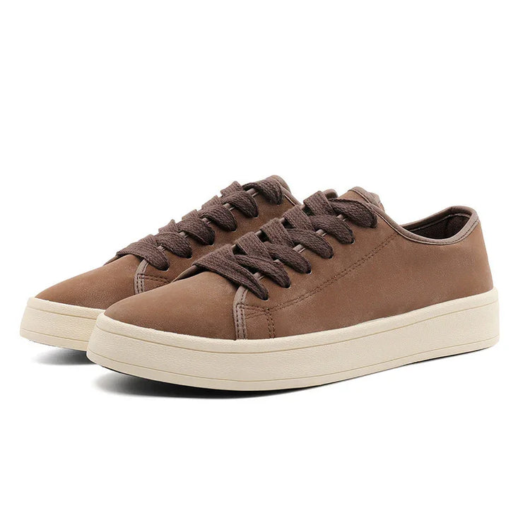 Brown suede low-top sneakers with thick white rubber soles and round toes