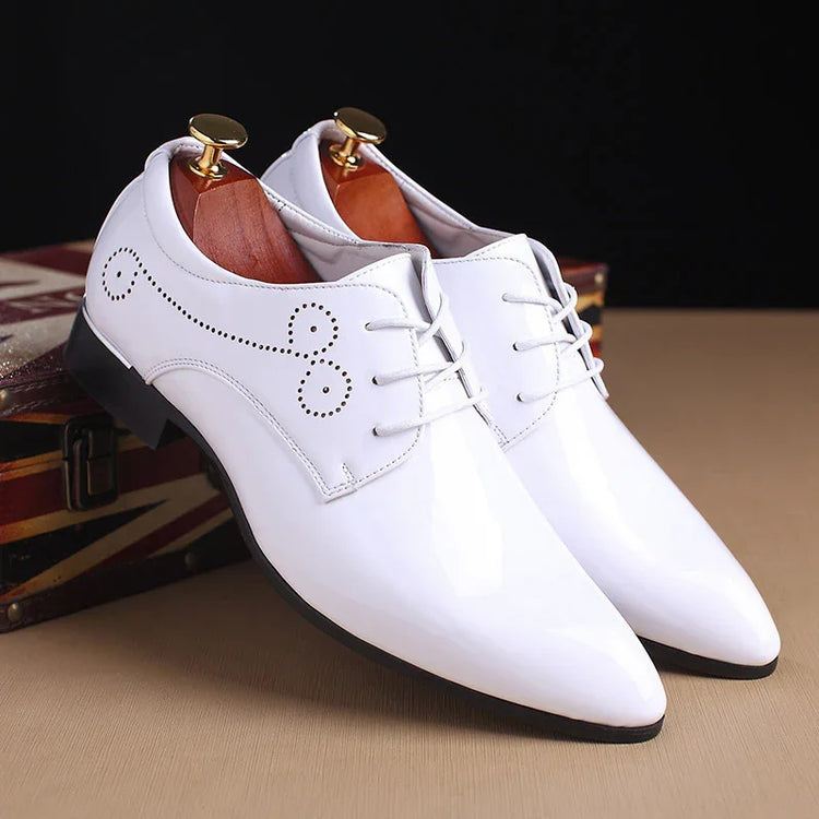 Glossy white dress shoes with pointed toe, lace-up closure, and perforated detailing.