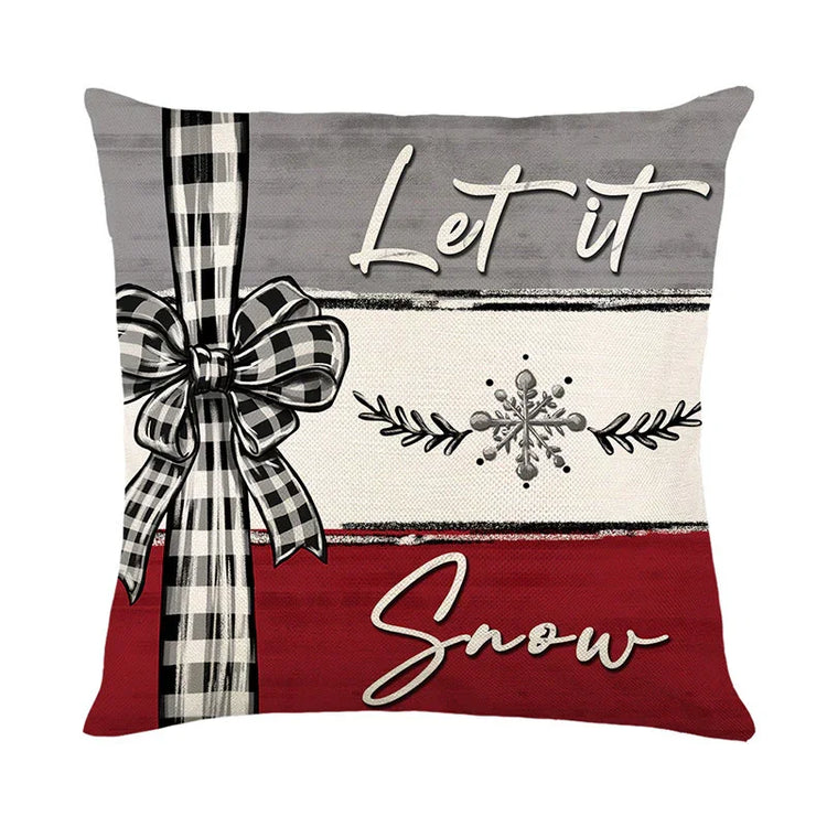 Festive pillow cover with plaid bow, snowflake design, red and gray color blocks, cozy holiday decor.