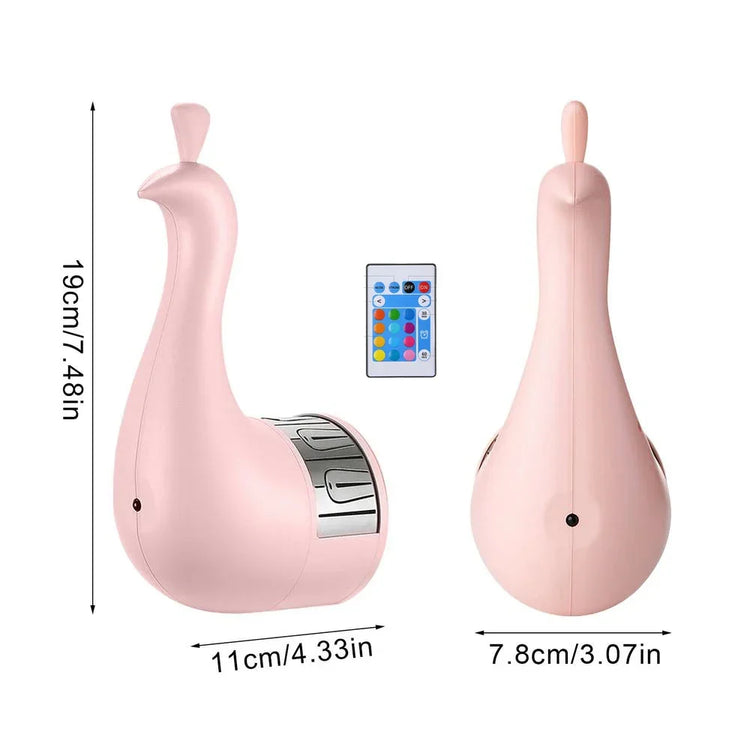 Pink duck-shaped gadget with silver accents, remote control, modern minimalist design