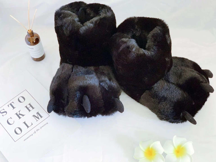Plush black faux fur slippers shaped like animal paws with claws, cozy indoor footwear