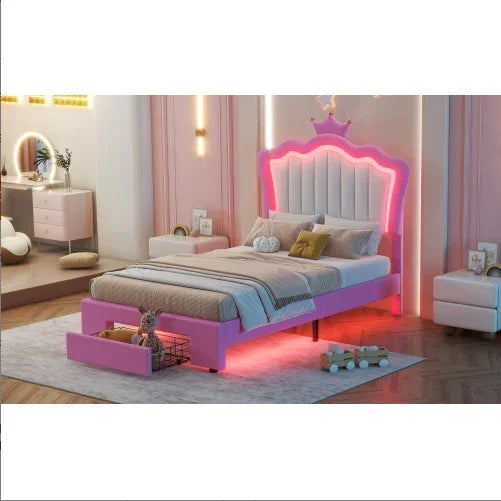 Pink upholstered bed with crown headboard, LED accent lighting, and soft neutral bedding in a modern bedroom