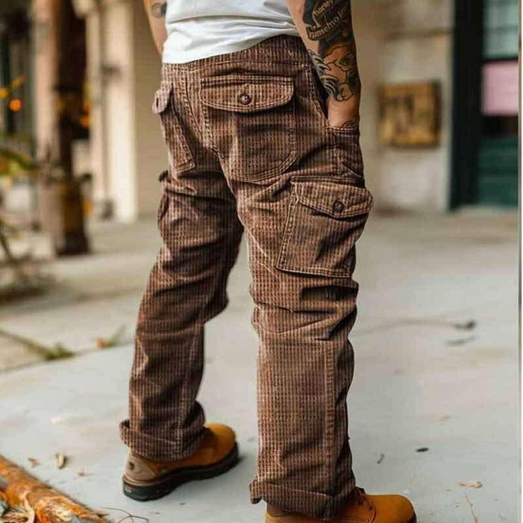 Brown corduroy cargo pants with relaxed fit and multiple pockets, outdoor streetwear style.