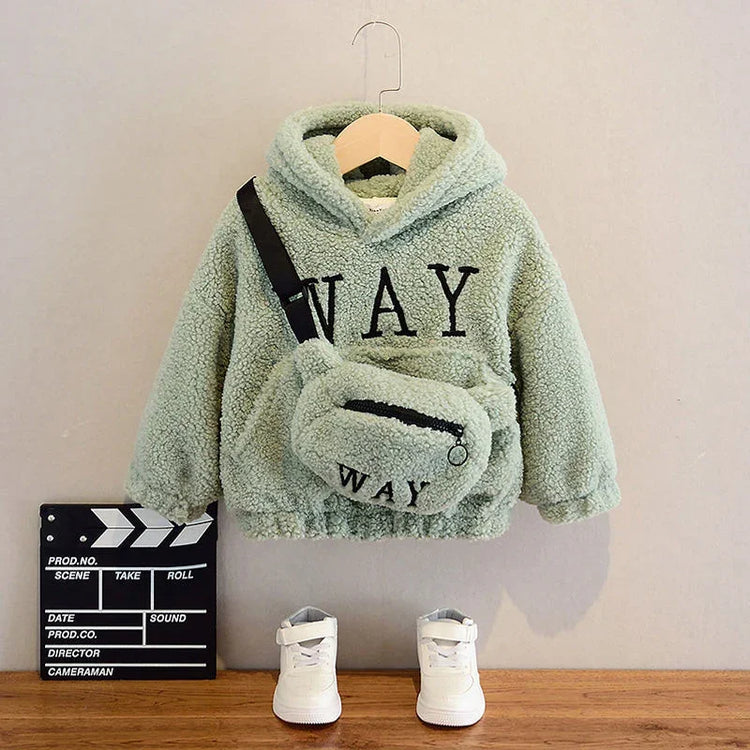 Light green sherpa hoodie with matching fuzzy crossbody bag and white sneakers, casual fit