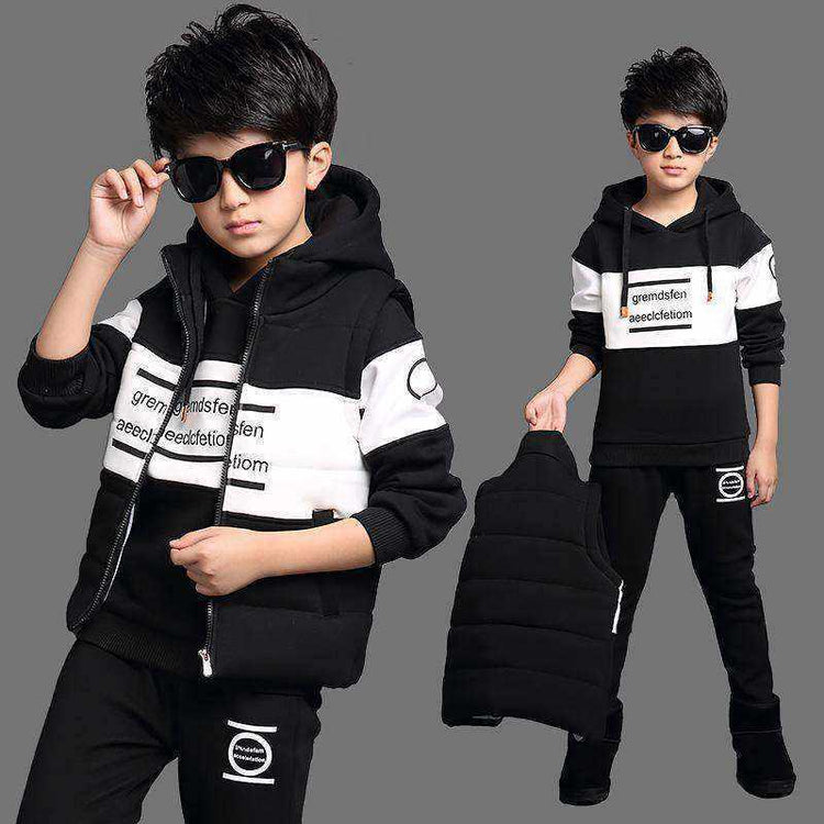 Boy wearing black and white streetwear tracksuit set with hooded sweatshirt and joggers