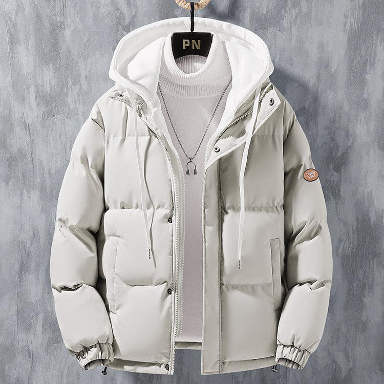 Light grey puffer jacket with hood, long sleeves, and relaxed fit, layered over turtleneck sweater.